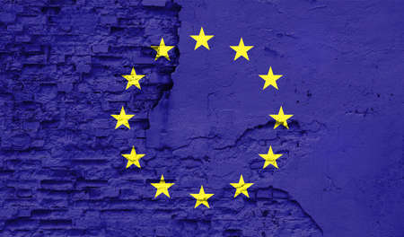 European Union flag is painted onto an old brick wall