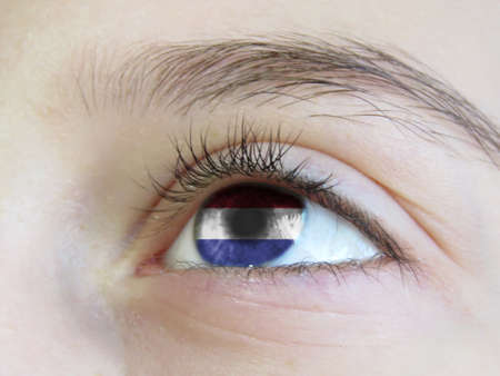 Portrait of a young girl with the color of the eyes of the flag of Netherlandsの写真素材
