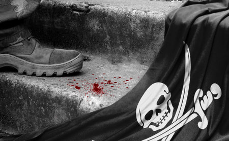 The leg of the military stands on the step next to the flag of Jolly Roger Pirates black, the concept of military conflictの写真素材
