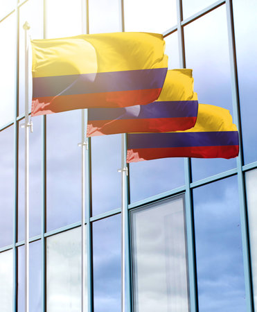 Flagpoles with the flag of Colombia in front of the business centerの写真素材