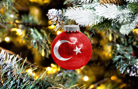 New Year's glass ball with the flag of Turkey against a colorful Christmas backgroundの写真素材