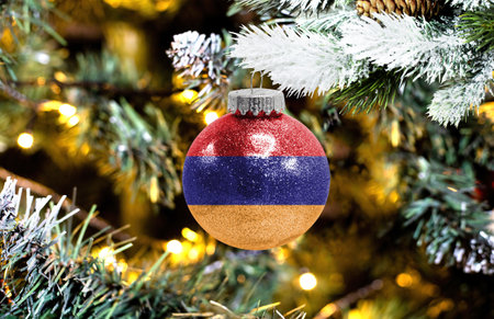 New Year's glass ball with the flag of Armenia against a colorful Christmas backgroundの写真素材