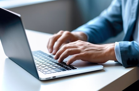 Close up of man hands typing text on laptop keyboard sitting at wooden table. Made with AI generationの素材