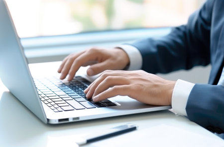 Close up of man hands typing text on laptop keyboard sitting at wooden table. Made with AI generationの素材