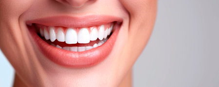 Beautiful female smile after teeth whitening procedure. Dental care. Dentistry concept.の素材