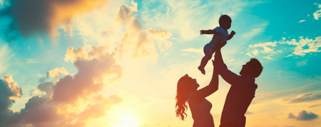 Dad and Mom raised a small child in their arms. Signs the family at sunset. People walk in nature. Side viewの素材