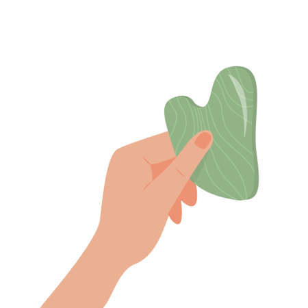 Gua Sha Jade scraping massage tool in hand. Natural green stone scraper. Facial massage. Face lifting. Skin care. Trendy beauty treatment. Vector flat illustration isolated on whiteのイラスト素材