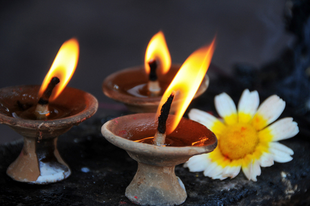 The burning candle and small chrysanthemumの写真素材