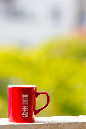 Red coffee cup on the window sillのeditorial素材