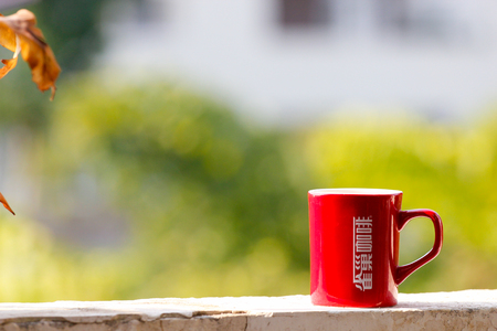 Red coffee cup on the window sillのeditorial素材