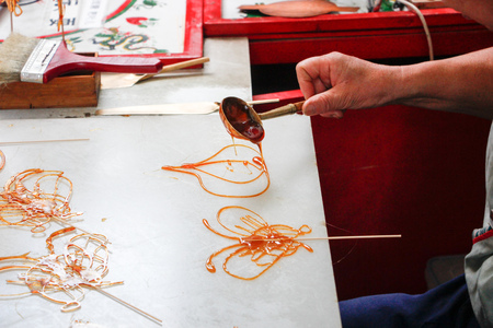 Traditional handicraft sugar painting in progressの写真素材