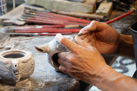 Close up view of a man carving on a stone in making a chopの写真素材