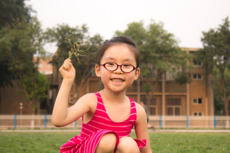 The cute little girl on the grassの写真素材