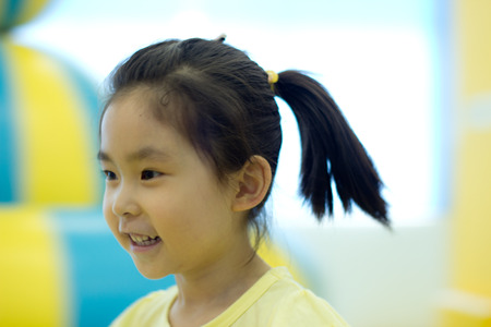 The little girl playing at the playgroundの写真素材