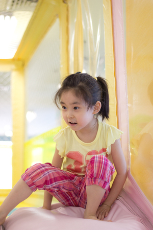 The little girl playing at the playgroundの写真素材