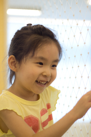 The little girl playing at the playgroundの写真素材