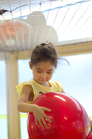 The little girl playing at the playgroundの写真素材
