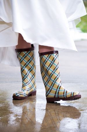 Close up of rain boot worn by a bride for a winter wedding