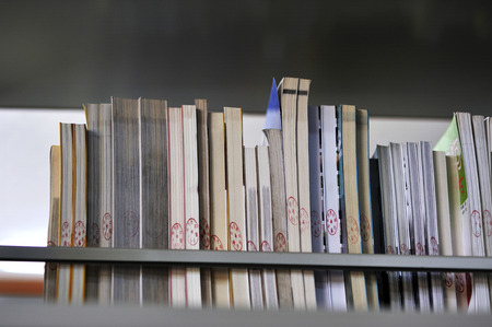 Choosing books to read in the library.のeditorial素材