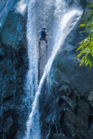 Rock climbing down the waterfallの写真素材