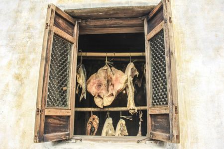Dried food hanging by the windowの写真素材
