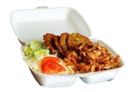 pork kebab with potato pancakes, vegetable garnish in a boxの写真素材