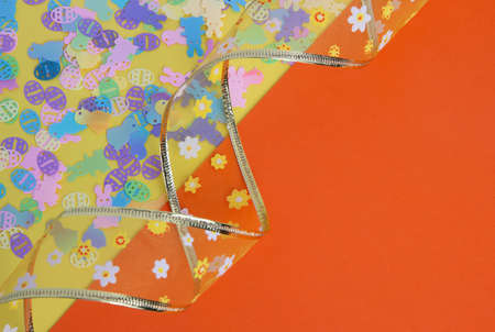 Easter background in orange color with ribbon and bunnies, chickens and eggs.の写真素材