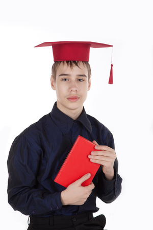 teenage boy with a book in konfederatkeの写真素材