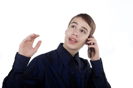 Happy teenager talking on the phone on white backgroundの写真素材