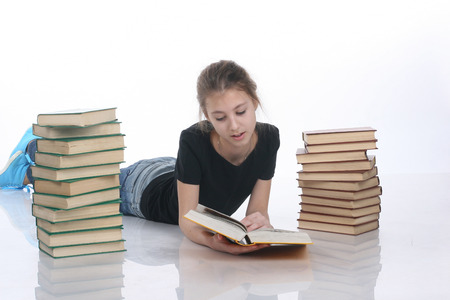 teenage girl with books isolated on white の写真素材