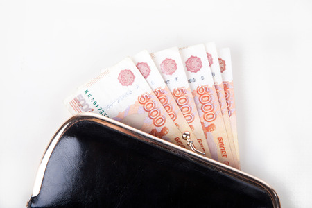 Ruble money in black purse on white background