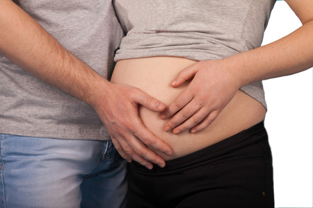 young couple expecting a child poyaleniya on a white backgroundの写真素材