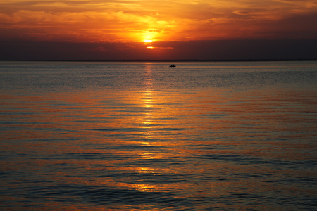 sunbeams falling through the clouds to the seaの写真素材