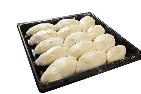 uncooked pies lay on a baking sheetの写真素材