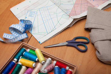 spools of thread, pins, centimeter on a wooden table