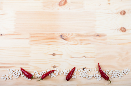 beans and pepper lie on a wooden tableの写真素材