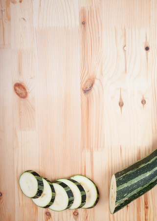 sliced zucchini lying on the wooden tableの写真素材