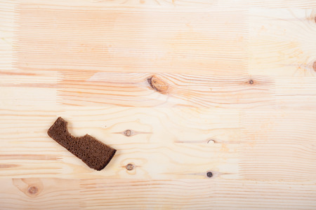 a slice of rye bread on a wooden tableの写真素材