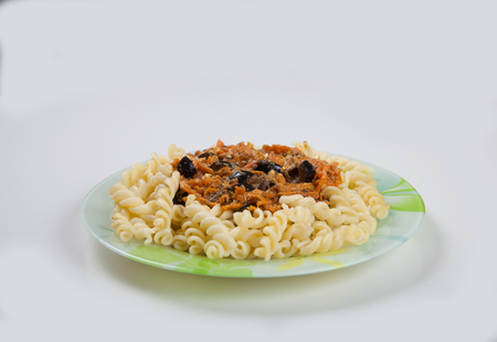 Boiled spaghetti with vegetables on a plate on a white backgroundの写真素材