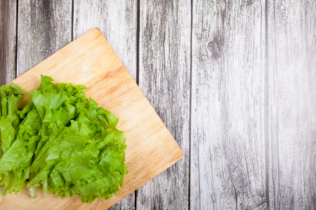 Green Lettuce leaves on a wooden backgroundの写真素材