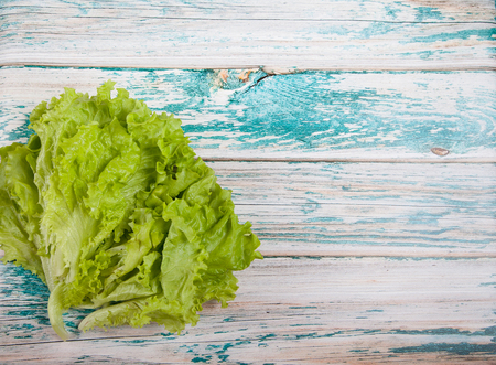 Green Lettuce leaves on a wooden backgroundの写真素材