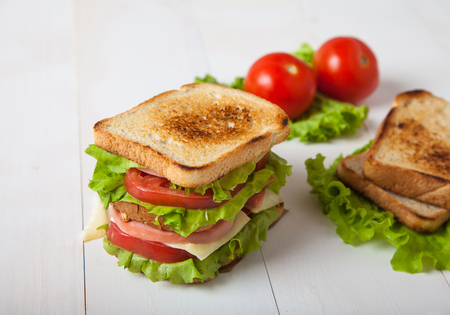 sandwich, tomato, toast, salad  on white wooden backgroundの写真素材