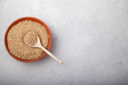 spelled groats lies in a clay cup on a white wooden background. superfoodの写真素材