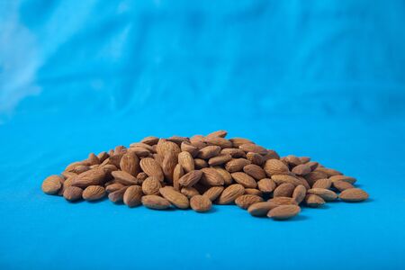 Almonds on a blue background. Copy spais. horizontallyの写真素材