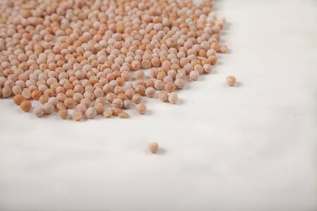 dried yellow raw peas scattered on a white background. Copy spaes. Horizontally.の写真素材