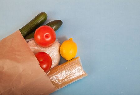 Products rice, pasta, tomatoes, cucumbers, lemon in a paper bag. Zero waste. Ecology.