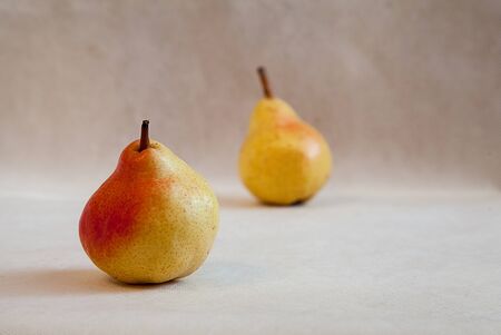 Ripe pear close-up on a gray background. Minimalism. Healthy food. Fresh food. Fruits.Vegetarianism.の写真素材