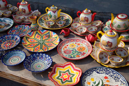 Sets of ceramic painted Uzbek tea ware with bowls and teapots and ceramic plates with national ornament April 29, 2019.のeditorial素材