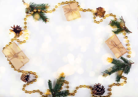Christmas round decoration from fir branches, cones and gifts on a white background. Holiday concept. Copy spaceの写真素材