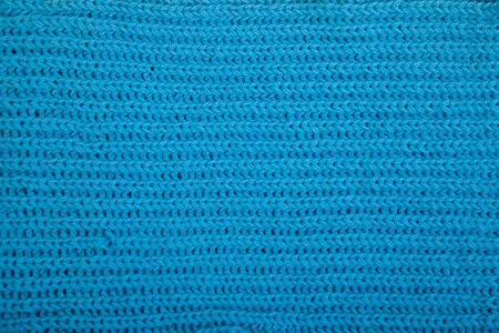 Fragment of a blue scarf knitted by hand. Flatlay